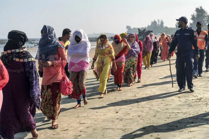 Rohingya-flygtningene bliver eskorteret af kystvagter. Foto: STR/Ritzau Scanpix